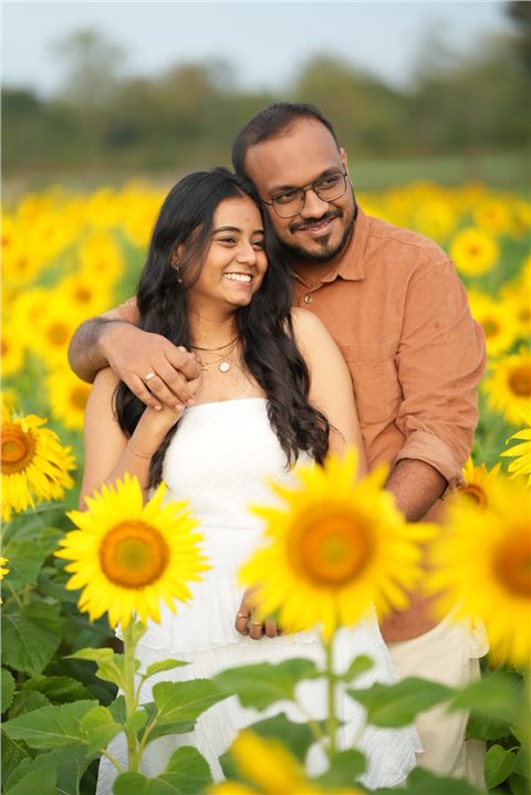 Akshay and Hansa embracing among sunflowers